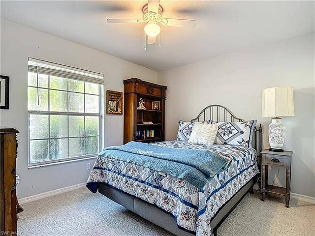 25735 Lake Amelia Way, #103, Bonita Springs, FL 34135 Bedroom with ceiling fan and light carpet