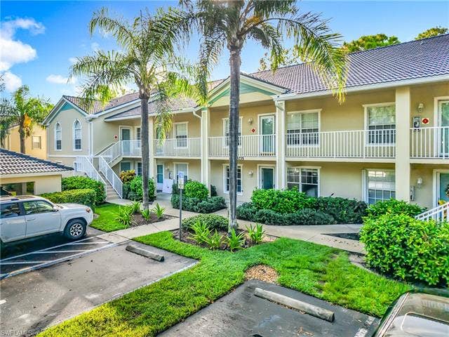 25735 Lake Amelia Way, #103, Bonita Springs, FL 34135 View of property featuring uncovered parking