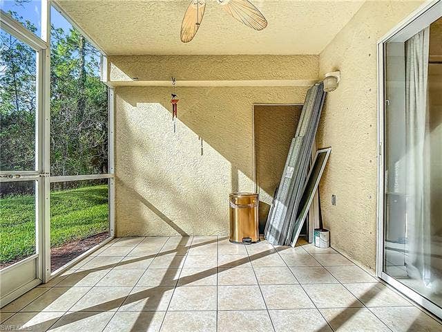 25735 Lake Amelia Way, #103, Bonita Springs, FL 34135 Unfurnished sunroom featuring ceiling fan