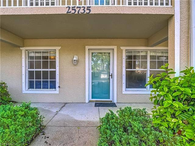 25735 Lake Amelia Way, #103, Bonita Springs, FL 34135 Property entrance featuring stucco siding