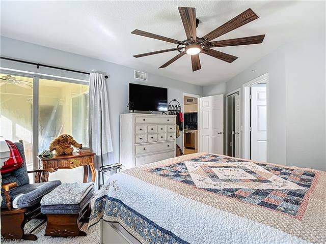 25735 Lake Amelia Way, #103, Bonita Springs, FL 34135 Carpeted bedroom with ceiling fan