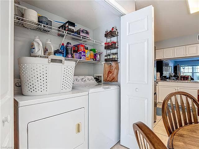 25735 Lake Amelia Way, #103, Bonita Springs, FL 34135 Laundry area featuring washing machine and clothes dryer