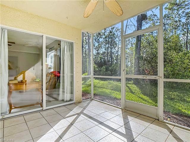 25735 Lake Amelia Way, #103, Bonita Springs, FL 34135 Unfurnished sunroom featuring ceiling fan