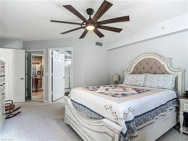 25735 Lake Amelia Way, #103, Bonita Springs, FL 34135 Carpeted bedroom featuring ceiling fan and high end fridge