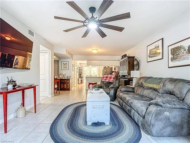25735 Lake Amelia Way, #103, Bonita Springs, FL 34135 Living room with light tile patterned floors and a ceiling fan