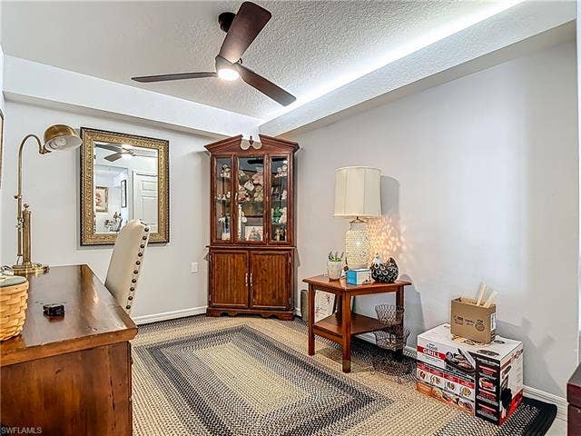 25735 Lake Amelia Way, #103, Bonita Springs, FL 34135 Office with a textured ceiling and carpet