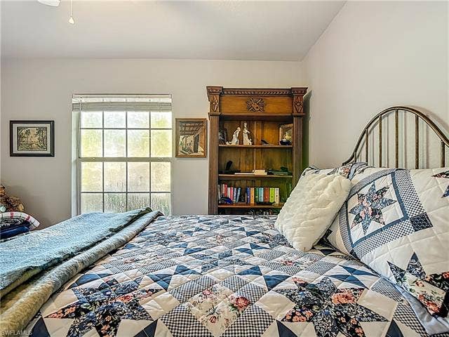 25735 Lake Amelia Way, #103, Bonita Springs, FL 34135 Bedroom featuring a ceiling fan