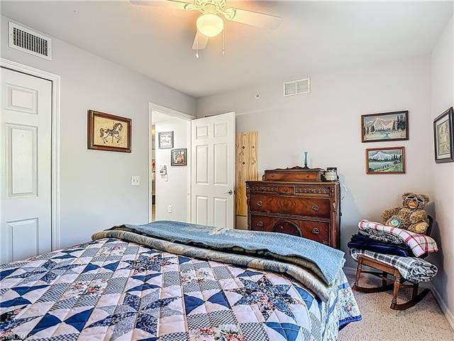 25735 Lake Amelia Way, #103, Bonita Springs, FL 34135 Bedroom with a ceiling fan and carpet floors