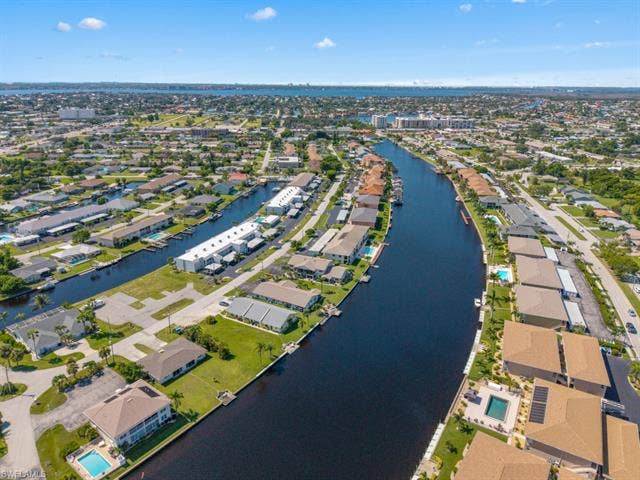 4520 5th Pl, Cape Coral, FL 33904 Aerial overview of property's location with a nearby body of water and nearby suburban area