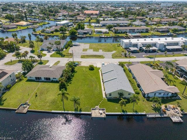 4520 5th Pl, Cape Coral, FL 33904 Aerial view of residential area with a large body of water