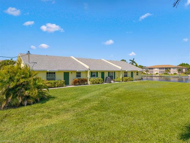 4520 5th Pl, Cape Coral, FL 33904 View of front of property with a front lawn
