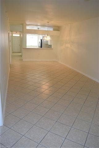 2350 Hidden Lake Ct, #8513, Naples, FL 34112 Empty room featuring baseboards and light tile patterned floors