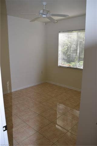 2350 Hidden Lake Ct, #8513, Naples, FL 34112 Empty room with ceiling fan and light tile patterned flooring