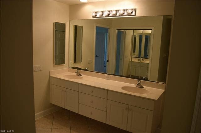 2350 Hidden Lake Ct, #8513, Naples, FL 34112 Bathroom featuring double vanity and light tile patterned floors