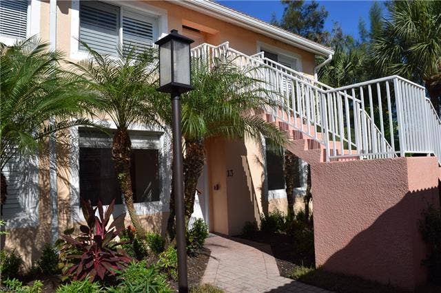 2350 Hidden Lake Ct, #8513, Naples, FL 34112 Doorway to property featuring stucco siding
