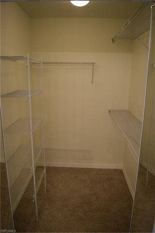 2350 Hidden Lake Ct, #8513, Naples, FL 34112 Walk in closet featuring dark carpet