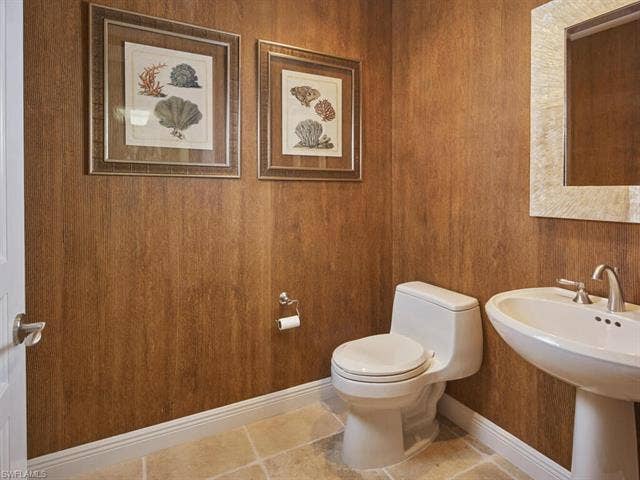 23750 Via Trevi Way, #2001, Estero, FL 34134 Bathroom featuring toilet and wood walls