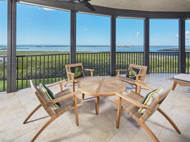 23750 Via Trevi Way, #2001, Estero, FL 34134 Sunroom / solarium featuring a water view, floor to ceiling windows, and tile patterned flooring