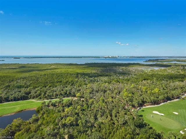 23750 Via Trevi Way, #2001, Estero, FL 34134 Aerial view of property's location featuring a nearby body of water and a golf course