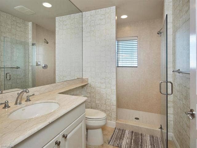 23750 Via Trevi Way, #2001, Estero, FL 34134 Full bath with vanity, a shower stall, recessed lighting, and light tile patterned flooring