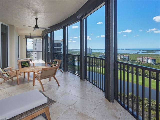 23750 Via Trevi Way, #2001, Estero, FL 34134 Sunroom with floor to ceiling windows, a water view, a textured ceiling, and tile patterned flooring