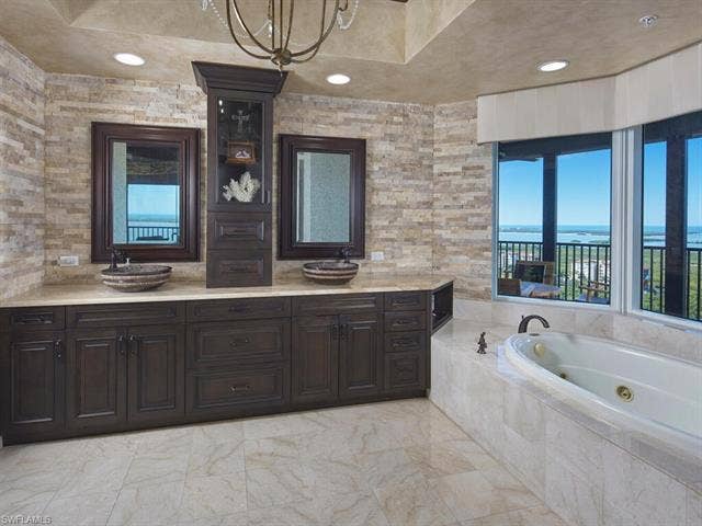 23750 Via Trevi Way, #2001, Estero, FL 34134 Bathroom featuring a whirlpool tub and double vanity
