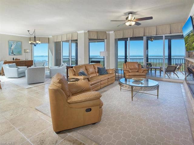 23750 Via Trevi Way, #2001, Estero, FL 34134 Living area with a chandelier, crown molding, and a ceiling fan