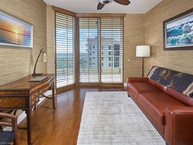 23750 Via Trevi Way, #2001, Estero, FL 34134 Sitting room with wallpapered walls, ceiling fan, dark wood-type flooring, and an office area