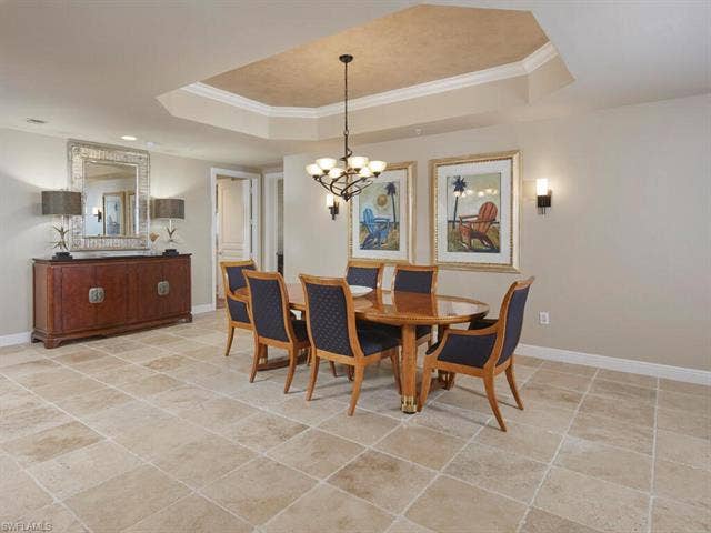 23750 Via Trevi Way, #2001, Estero, FL 34134 Dining space featuring ornamental molding, light tile patterned floors, and a chandelier