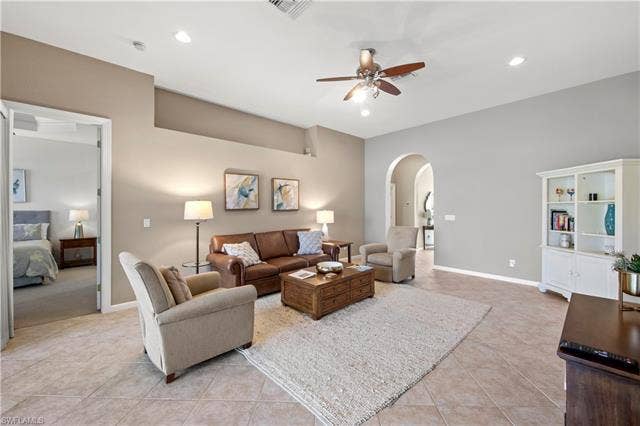 14546 Speranza Way, Bonita Springs, FL 34135 Living area featuring arched walkways, light tile patterned flooring, recessed lighting, and a ceiling fan