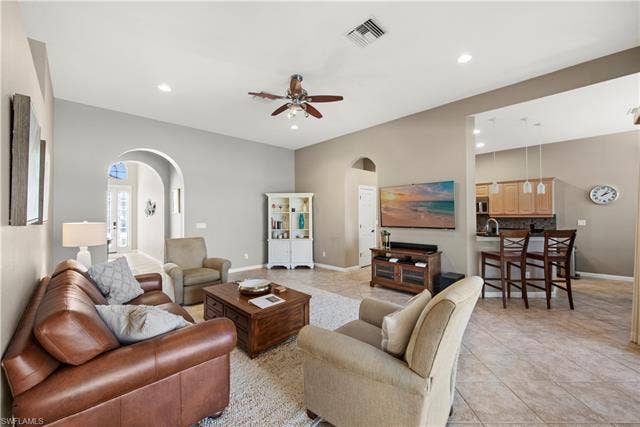 14546 Speranza Way, Bonita Springs, FL 34135 Living room featuring arched walkways, light tile patterned flooring, ceiling fan, and recessed lighting
