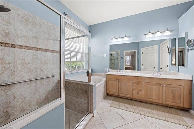 14546 Speranza Way, Bonita Springs, FL 34135 Bathroom with a shower stall, double vanity, a bath, and light tile patterned floors