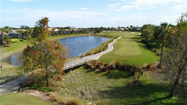 14546 Speranza Way, Bonita Springs, FL 34135 Water view with a golf club and nearby suburban area