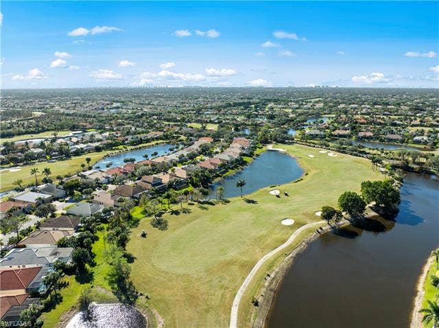 14546 Speranza Way, Bonita Springs, FL 34135 Aerial view of property's location with a local golf course, nearby suburban area, and a nearby body of water