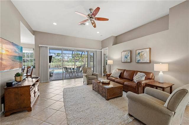 14546 Speranza Way, Bonita Springs, FL 34135 Living room featuring a sunroom, a ceiling fan, healthy amount of natural light, light tile patterned floors, and recessed lighting