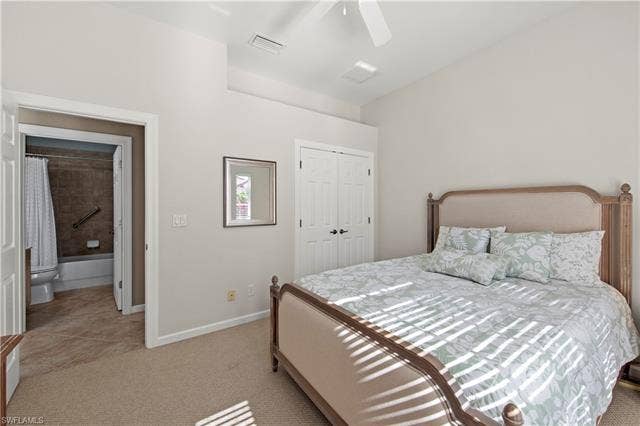 14546 Speranza Way, Bonita Springs, FL 34135 Bedroom featuring light carpet, a closet, a ceiling fan, and light tile patterned flooring