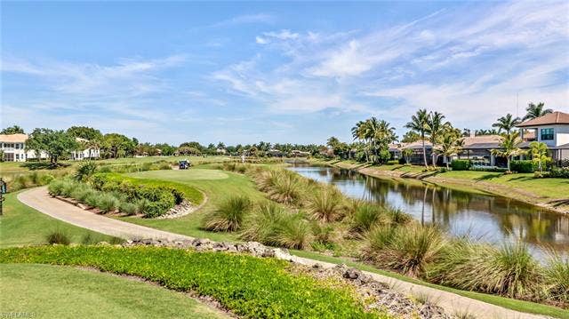 14546 Speranza Way, Bonita Springs, FL 34135 View of property's community with a water view, a residential view, and a yard