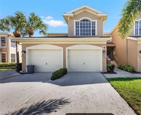 23007 Lone Oak Dr, Estero, FL 33928 View of front of house with stucco siding and driveway