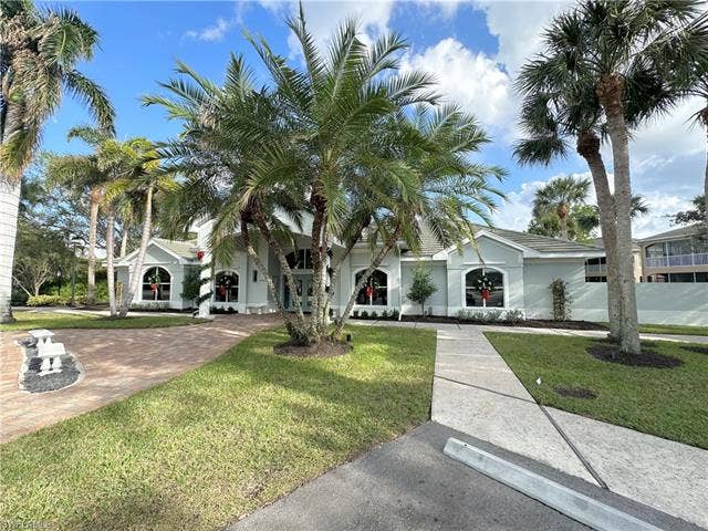 23007 Lone Oak Dr, Estero, FL 33928 View of front of property featuring a front lawn and stucco siding