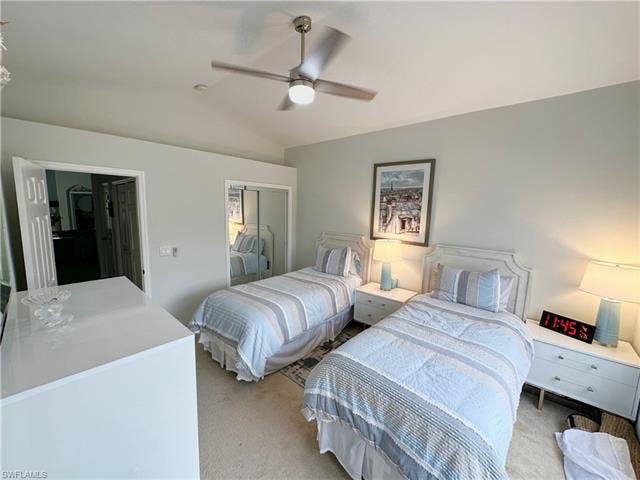 23007 Lone Oak Dr, Estero, FL 33928 Carpeted bedroom with lofted ceiling, a closet, and ceiling fan