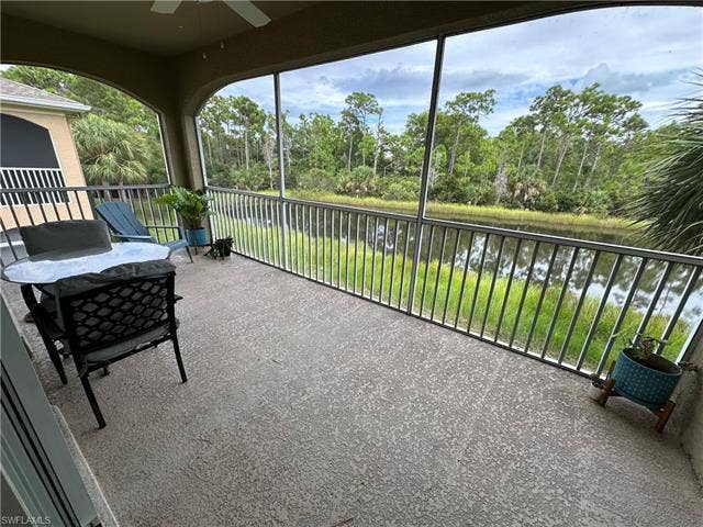 23007 Lone Oak Dr, Estero, FL 33928 Sunroom / solarium with a water view and view of wooded area