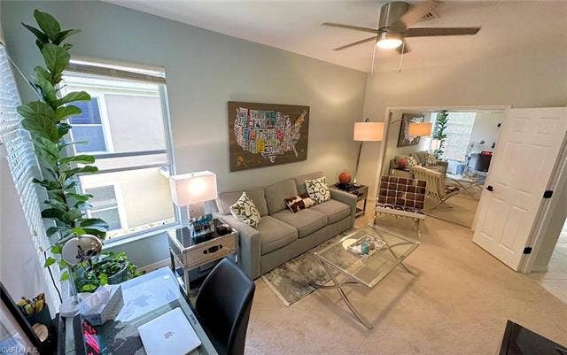 23007 Lone Oak Dr, Estero, FL 33928 Carpeted living area featuring a desk and ceiling fan