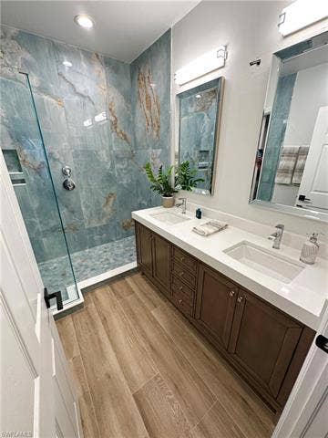 23007 Lone Oak Dr, Estero, FL 33928 Full bath with a marble finish shower, double vanity, wood finish floors, and recessed lighting