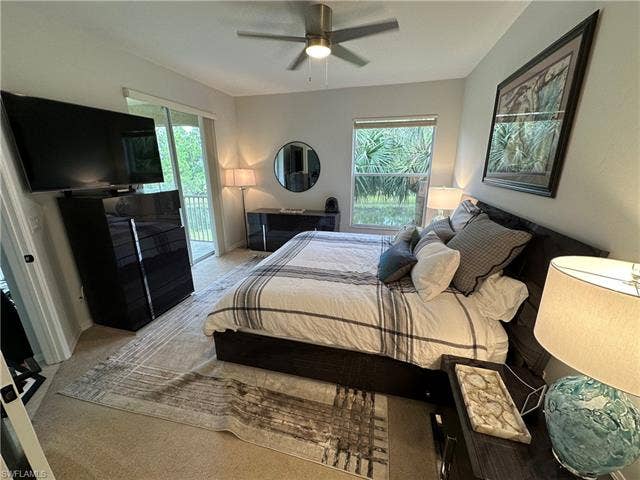 23007 Lone Oak Dr, Estero, FL 33928 Bedroom featuring carpet flooring, access to exterior, ceiling fan, and multiple windows