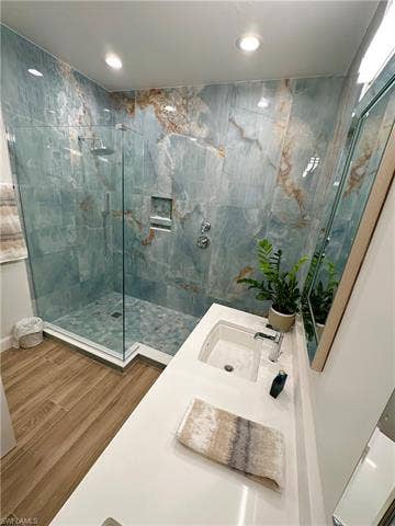 23007 Lone Oak Dr, Estero, FL 33928 Bathroom with vanity, a marble finish shower, wood finished floors, and recessed lighting