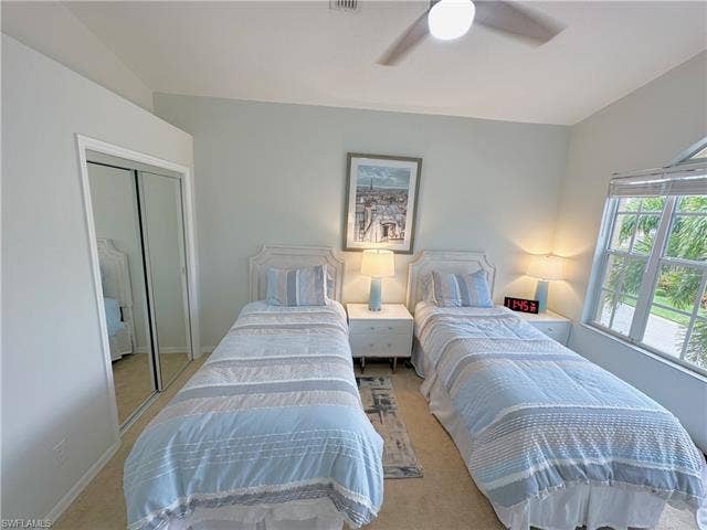 23007 Lone Oak Dr, Estero, FL 33928 Bedroom featuring ceiling fan, a closet, and carpet flooring