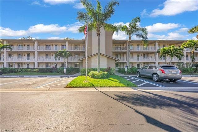 7320 Glenmoor Ln, #2304, Naples, FL 34104 View of apartment building / complex with uncovered parking