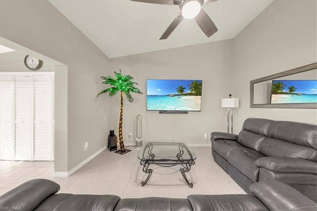 7320 Glenmoor Ln, #2304, Naples, FL 34104 Living room featuring vaulted ceiling and ceiling fan