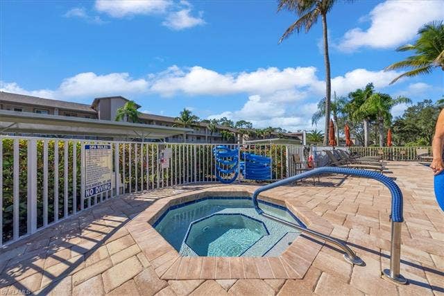 7320 Glenmoor Ln, #2304, Naples, FL 34104 View of swimming pool featuring a pool, a hot tub, and a patio