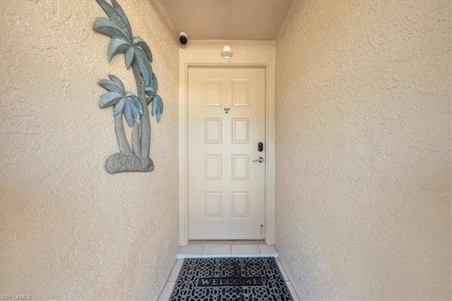 7320 Glenmoor Ln, #2304, Naples, FL 34104 Property entrance with stucco siding